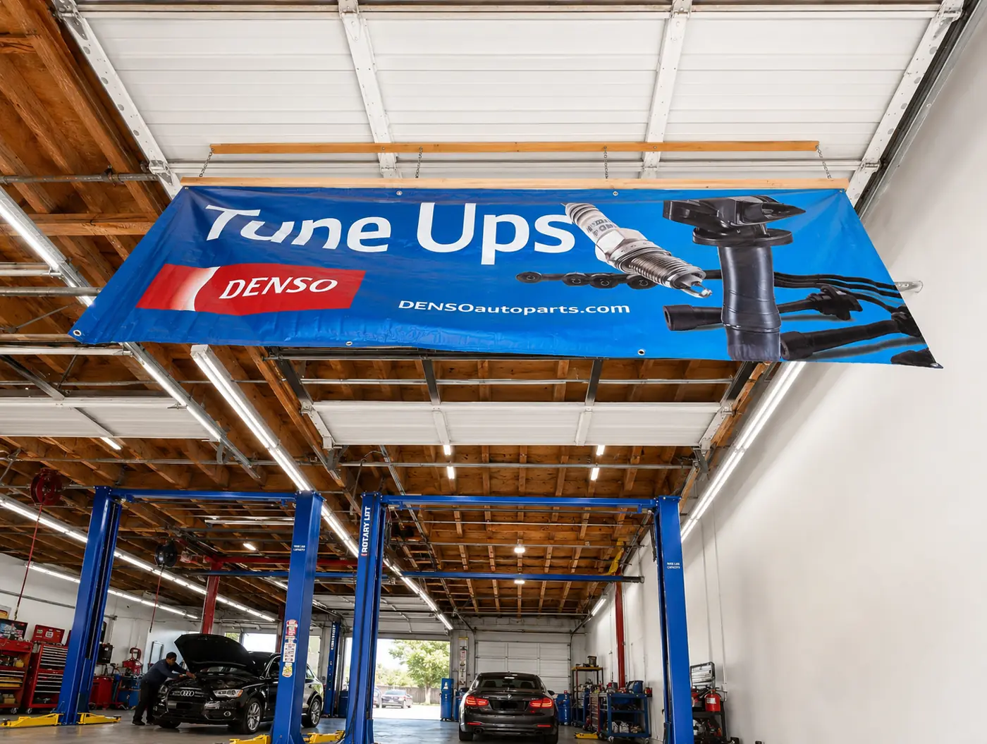 Service bays with blue two-post lifts under a Tune Ups banner